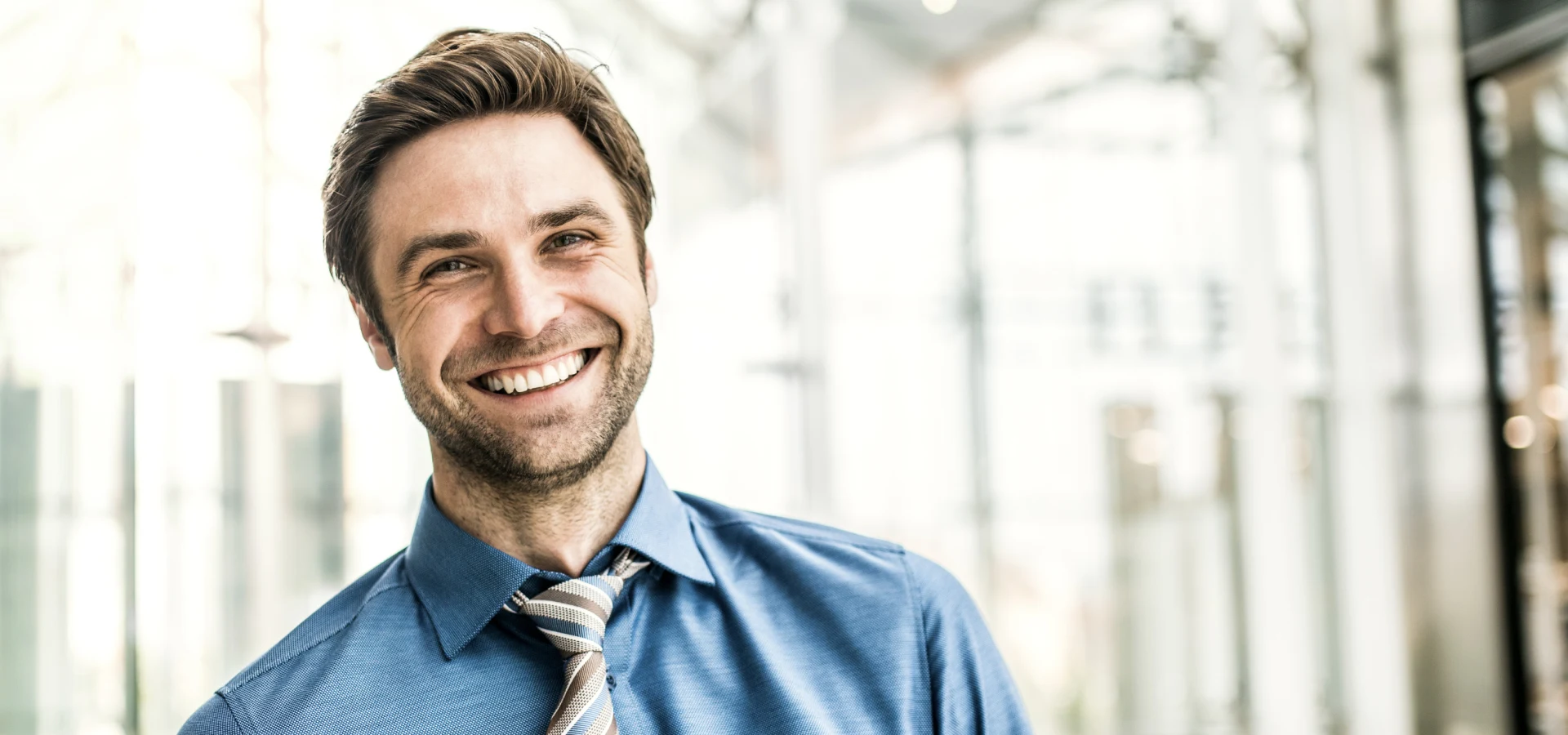 Smiling man formally dressed in blue shirt